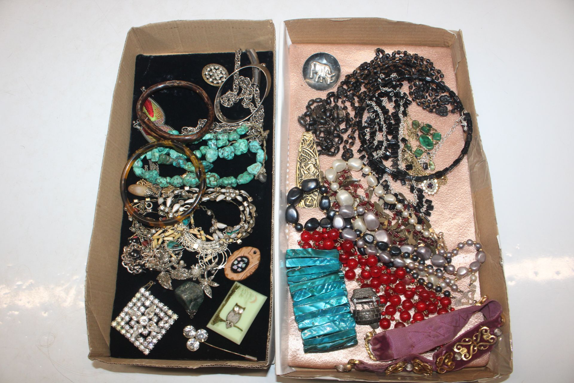 Two trays of assorted costume jewellery to include