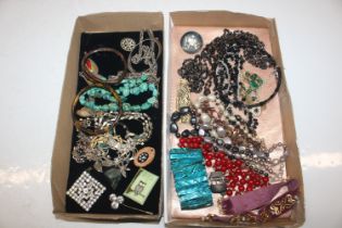 Two trays of assorted costume jewellery to include