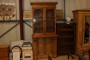 A 19th Century continental stripped pine bookcase on cupboard base