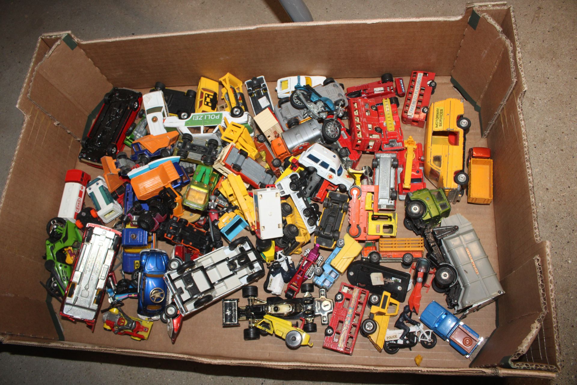 A box of various die-cast toy vehicles (mostly play worn)
