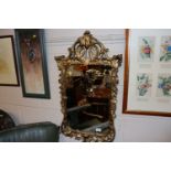 A gilt framed Florentine style wall mirror