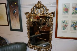 A gilt framed Florentine style wall mirror