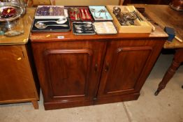 A mahogany two door cabinet fitted sliding trays a