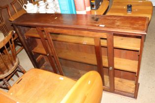 A mahogany low display cabinet enclosed by glazed