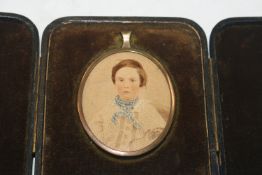 An oval framed miniature portrait contained in fit