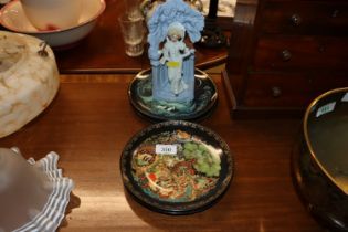 Four collector's plates; and a porcelain figural s