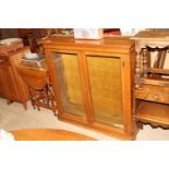 A Victorian walnut bookcase enclosed by glazed pan