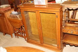 A Victorian walnut bookcase enclosed by glazed pan