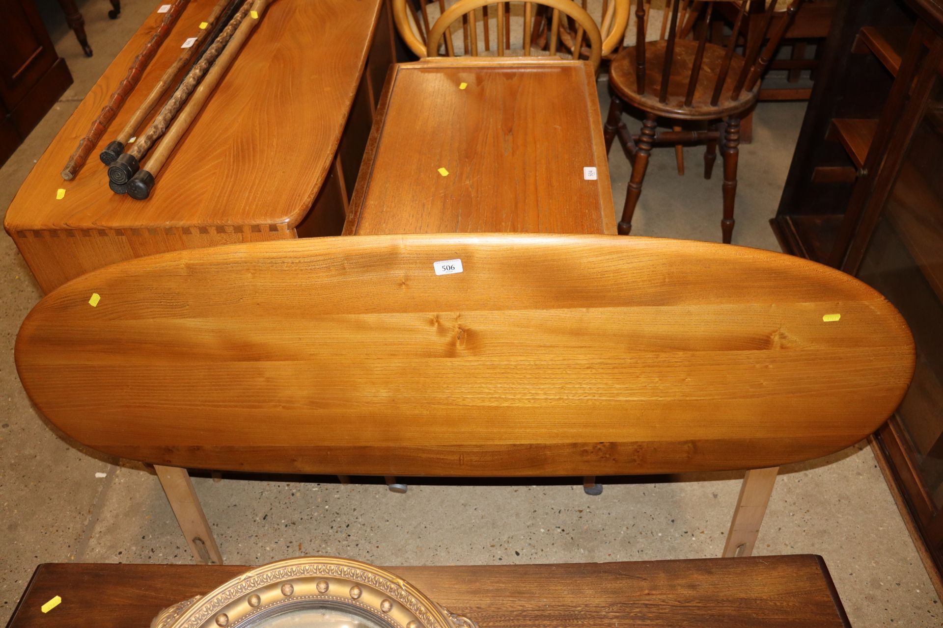 A blonde Ercol oval shaped bedhead