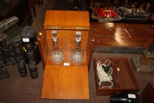 A wooden cased two bottle Tantalus