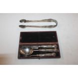 A case containing silver knife, fork and spoon and