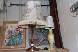A brass and copper table lamp with floral decorate