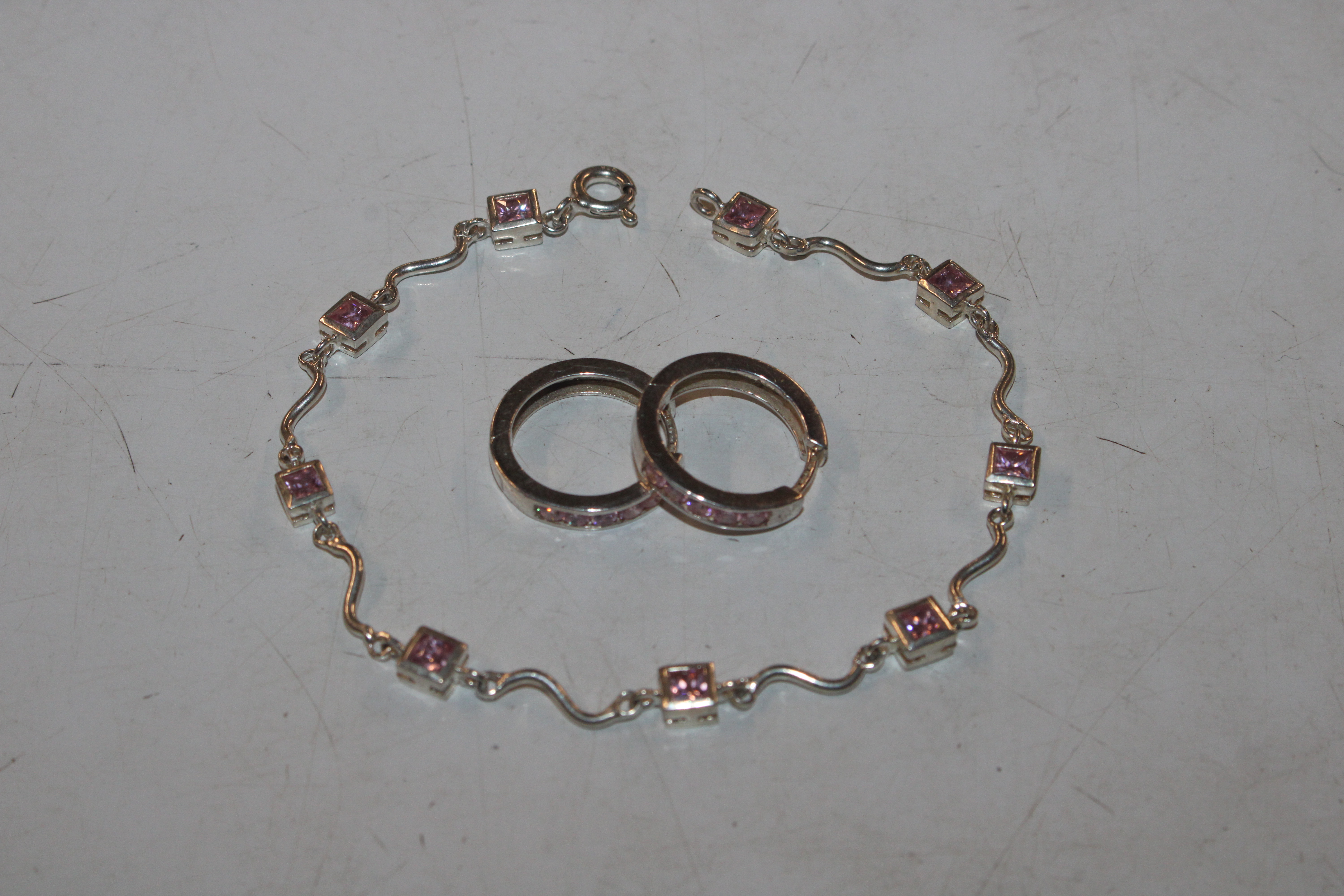 A Sterling silver and pink topaz bracelet and ear-