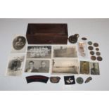 A box of mixed badges, coins, medals, WWI compass