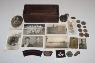A box of mixed badges, coins, medals, WWI compass