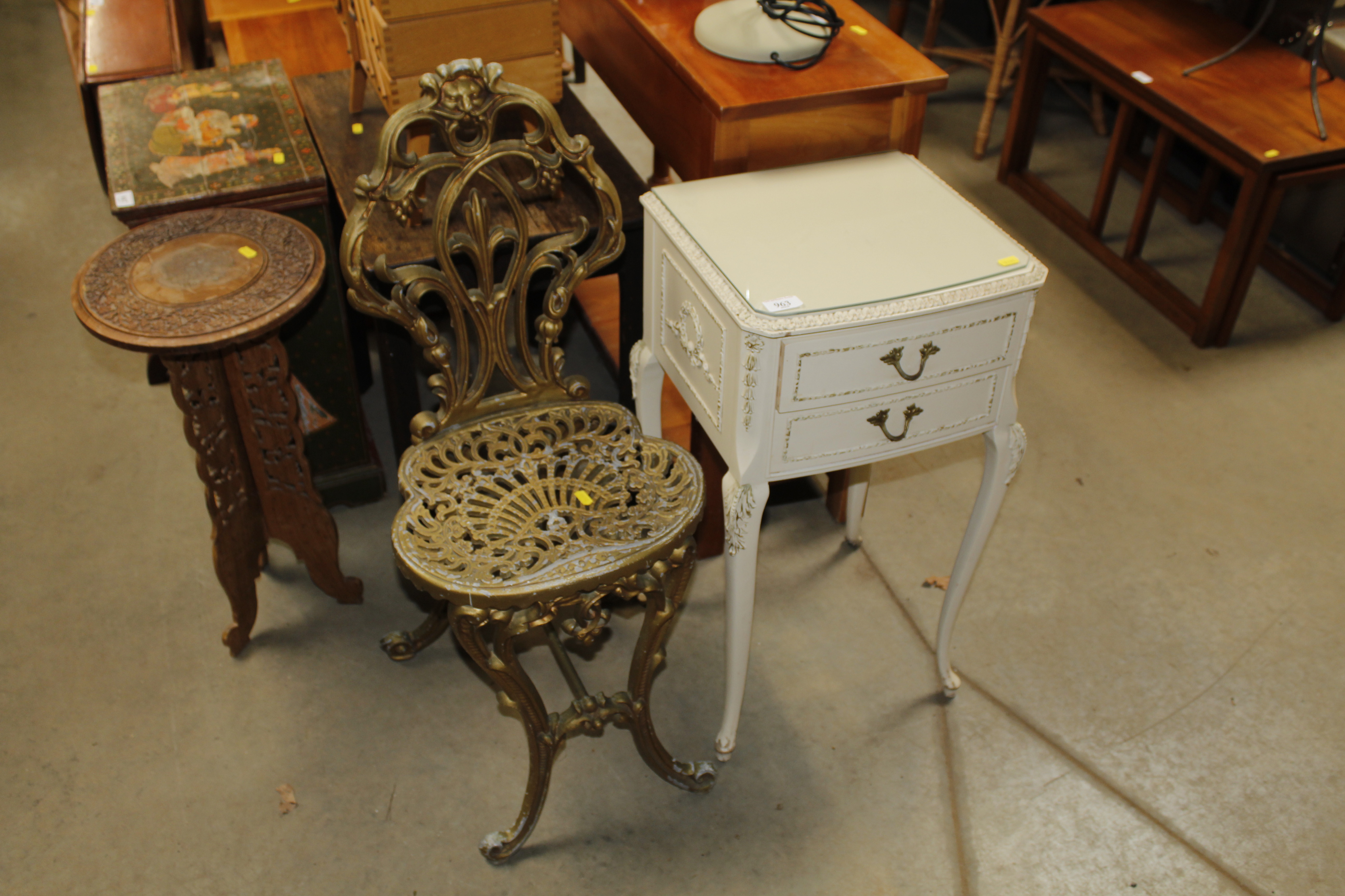 A cream and gilt bedside table fitted two drawers