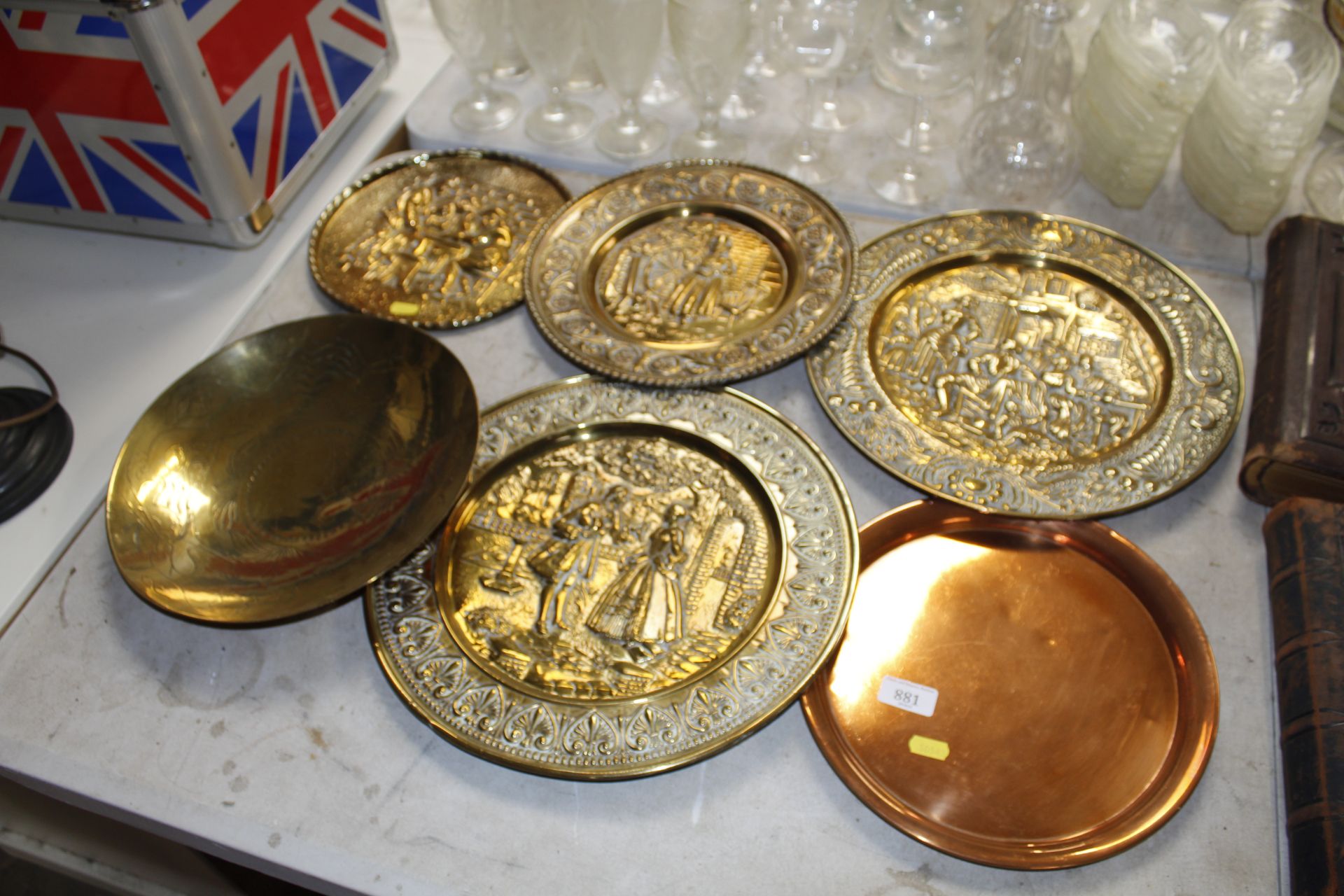 Four brass wall plaques, a brass bowl and a copper