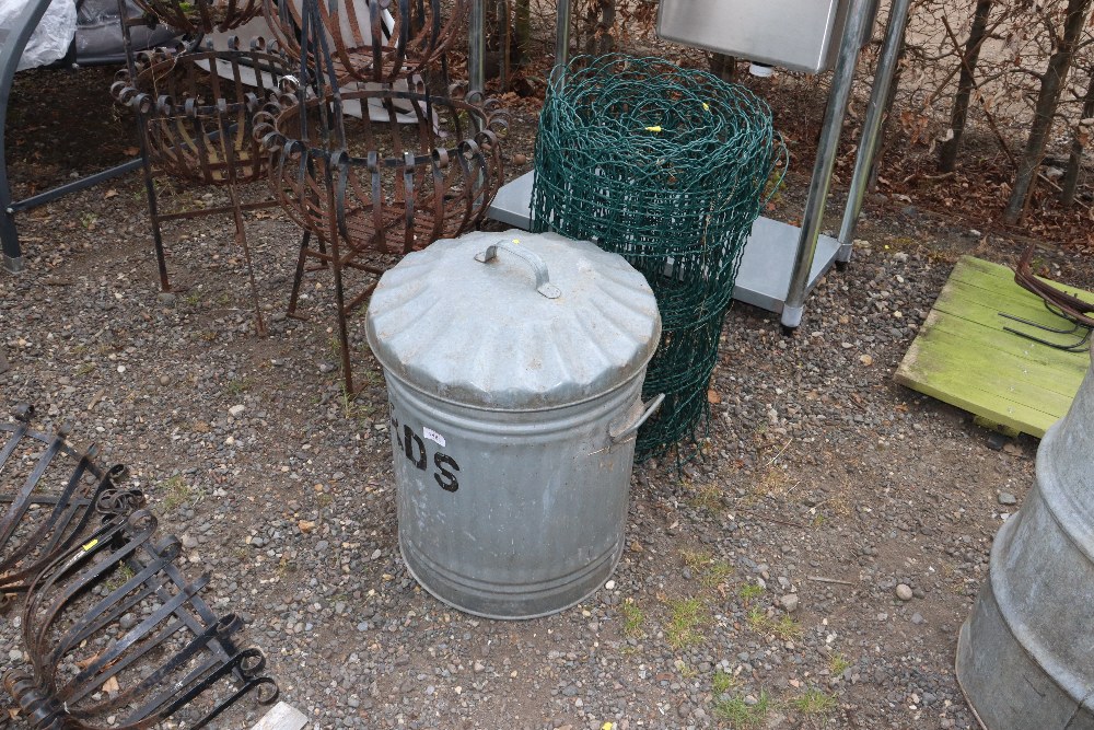 A galvanised dustbin with lid and twin handles tog