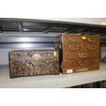 A carved wooden jewellery box and a jewellery ches