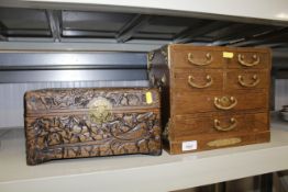 A carved wooden jewellery box and a jewellery ches