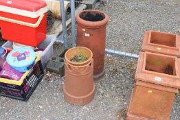 A terracotta chimney pot; a plastic chimney top an