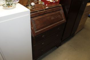 An oak bureau fitted three drawers