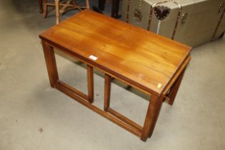 A teak nest of three occasional tables