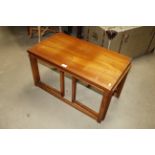 A teak nest of three occasional tables