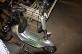 An E-Scooter with charger, spare wheel and key, so