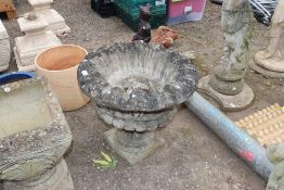 A large concrete urn shaped planter