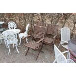 Three varnished wooden folding garden armchairs