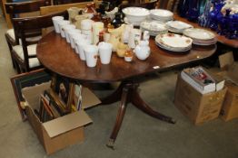 A reproduction mahogany drop leaf dining table and