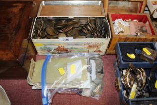 A tin containing various copper coinage; bank note