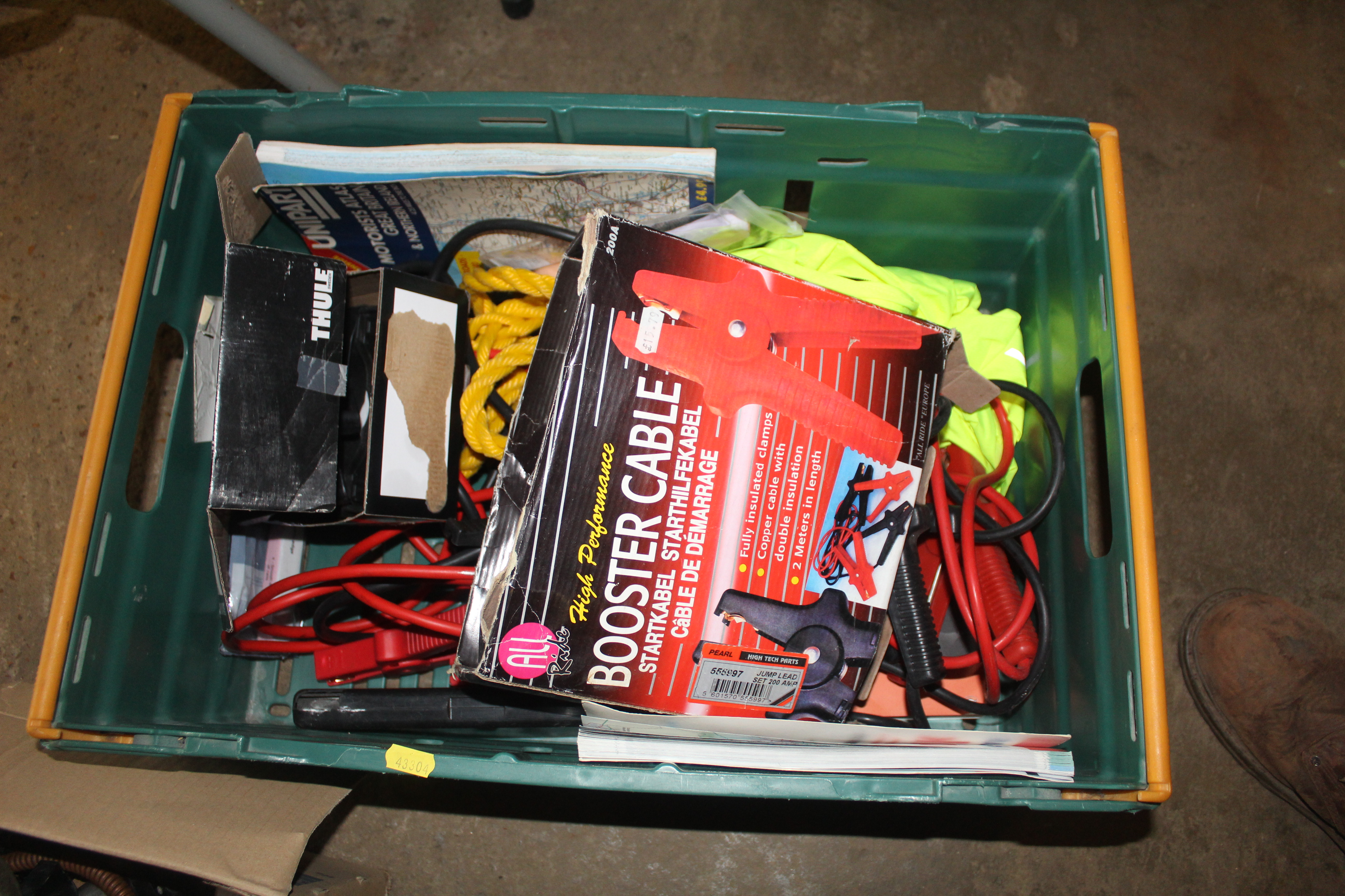 A box containing two sets of jump leads, rope, flu