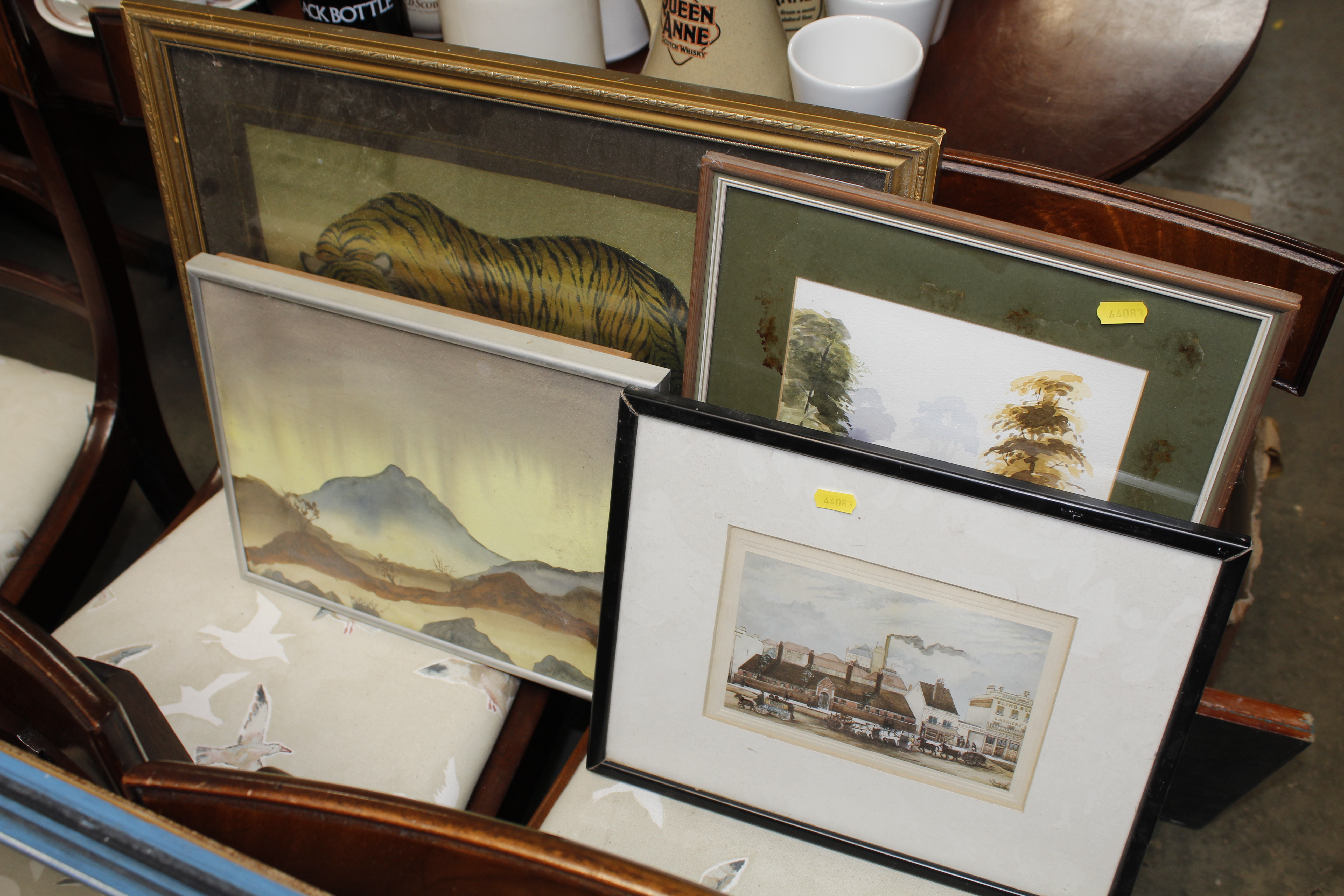 A watercolour of landscape scene and three prints