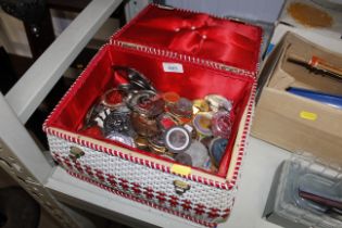 A sewing basket and contents of various medals