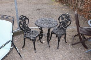 An ornate cast iron and black painted circular tabl