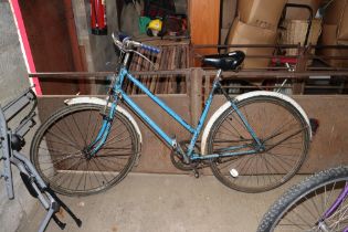 A vintage ladies bicycle with fitted front and rea
