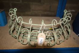 A green painted wrought metal wall mounting plante