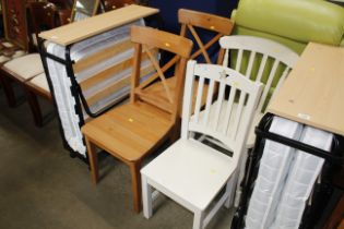 A pair of pine chairs together with two white slat