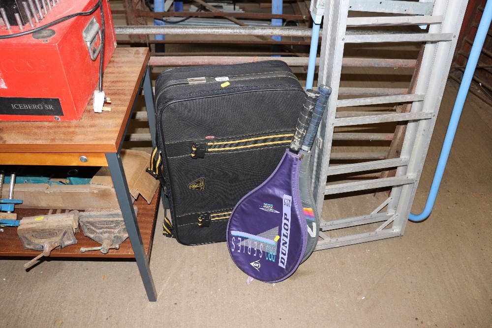 A fabric travel case and two tennis racquets