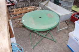 A green painted metal folding garden table