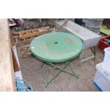 A green painted metal folding garden table