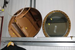 A gilt framed bevelled edge oval wall mirror and a