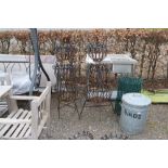 A pair of ornate wrought metal three tier planters