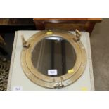 A brass porthole mirror