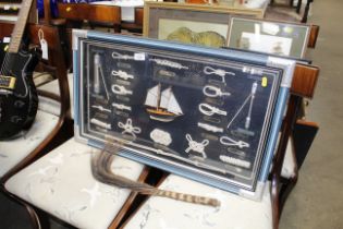 A framed and glazed display of ships knots and a f