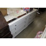 A pair of white bedroom chests fitted three drawers