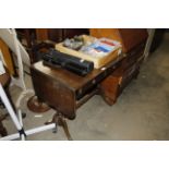 A reproduction drop leaf mahogany sofa table