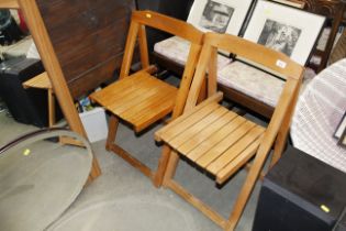 A pair of folding wooden chairs